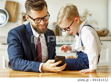 businessman father with a young schoolboy son 69181312