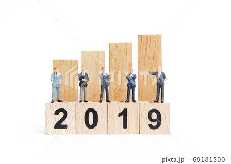 Miniature people : businessman  standing and thinking on wooden block number 2019 69181500