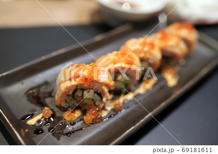 c Topped with orange flying fish roe In a square plate In a japanese restaurant. Selective focus. c Topped with orange flying fish roe In a square plate In a japanese restaurant. Selective focus. 69181611