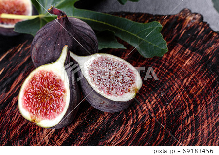 Fresh ripe figs on a dark concrete background. Harvesting figs Fresh ripe figs on a dark concrete background. Harvesting figs 69183456