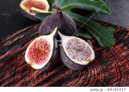 Fresh ripe figs on a dark concrete background. Harvesting figs Fresh ripe figs on a dark concrete background. Harvesting figs 69183457