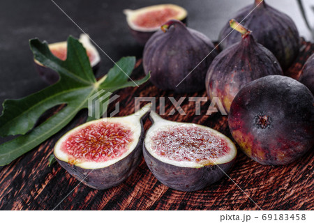 Fresh ripe figs on a dark concrete background. Harvesting figs Fresh ripe figs on a dark concrete background. Harvesting figs 69183458