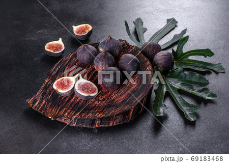 Fresh ripe figs on a dark concrete background. Harvesting figs 69183468