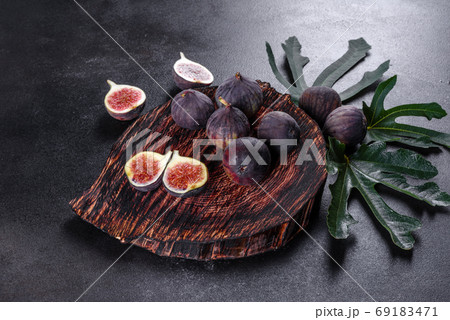 Fresh ripe figs on a dark concrete background. Harvesting figs 69183471