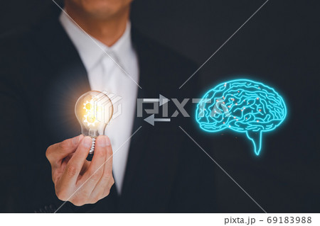 Businessmen hold the light bulb with a brain icon Businessmen hold the light bulb with a brain icon 69183988