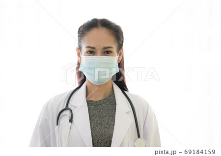 Asian female doctor wearing medical mask isolated on white background. Coronavirus outbreak. Asian female doctor wearing medical mask isolated on white background. Coronavirus outbreak. 69184159