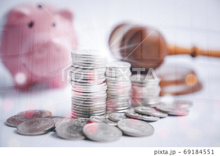 Coins stack and pink piggy and Old wood Judge hammer with line graph  69184551
