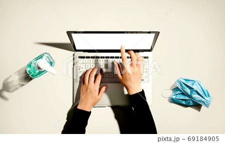 Laptop computer with hand sanitizer and masks 69184905