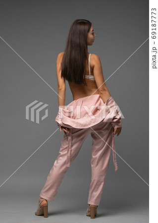 Woman in beautiful lingerie takes off her jumpsuit 69187773