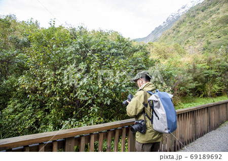 ニュージーランド、南島、ウェストランド国立公園のフランツ・ジョセフ氷河を旅行するアクティブシニア男性 69189692