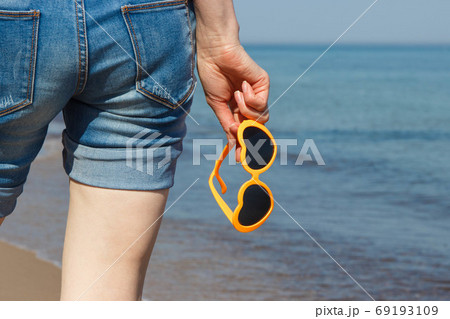 Hand of woman with sunglasses in shape of heart. Summer time 69193109