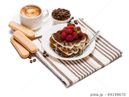 portion of Classic tiramisu dessert with raspberries and cup of fresh hot espresso isolated on white background - clipping path 69198670