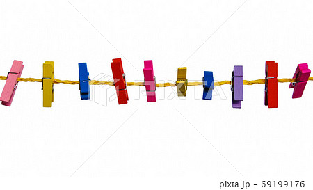 colored wooden clothespins on a yellow rope on a white background 69199176