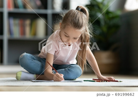 Pretty little girl playing on warm floor, drawing with pencils Pretty little girl playing on warm floor, drawing with pencils 69199662
