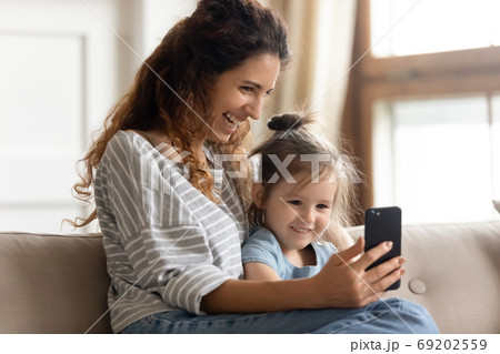 Mother her little daughter enjoy distant talk by videoconference app Mother her little daughter enjoy distant talk by videoconference app 69202559