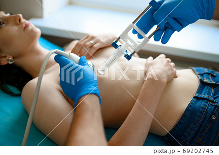 Male mammologist treats woman in clinic Male mammologist treats woman in clinic 69202745