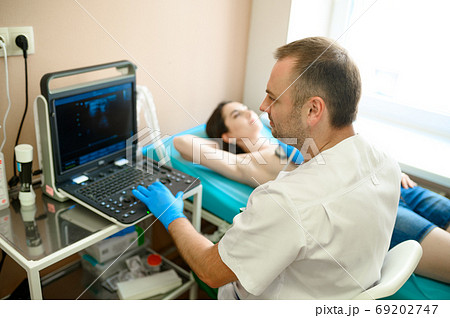 Male mammologist makes breast ultrasound scanning Male mammologist makes breast ultrasound scanning 69202747