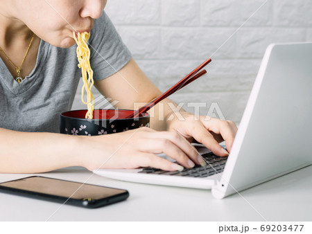 Smart business women work eat food Instant noodles Laptop comput Smart business women work eat food Instant noodles Laptop comput 69203477