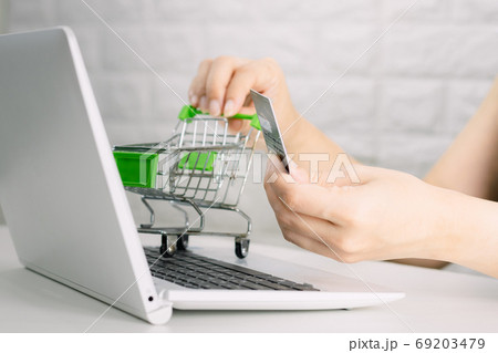 Hands holding credit card on the keyboard online shopping on lap 69203479