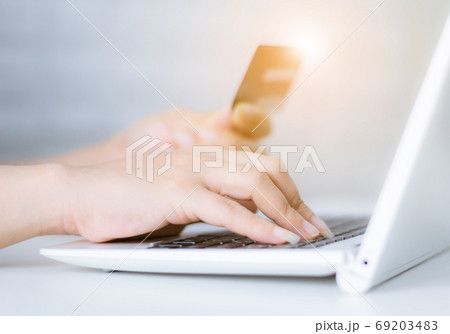 Hands holding credit card on the keyboard online shopping on lap 69203483