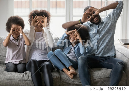 Playful little african american children having fun with parents. 69203919