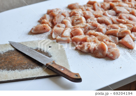 Chopped chicken fillet with a knife on table Chopped chicken fillet with a knife on table 69204194