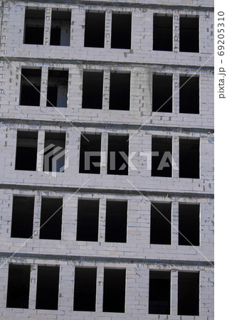 New multi-storey ready for commissioning white brick building against blue sky, free space for text 69205310