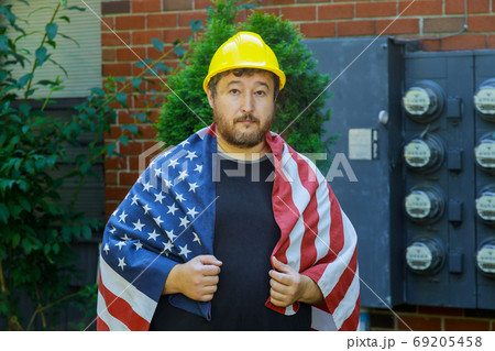 Labor day concept for worker in a yellow helmet Labor day concept for worker in a yellow helmet 69205458