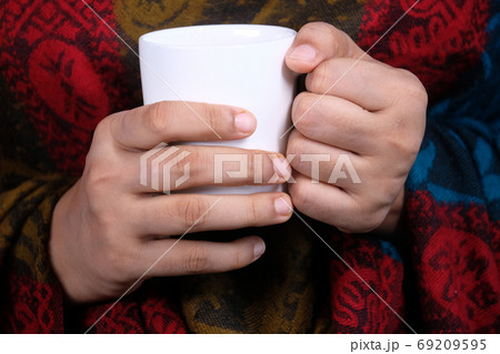 Close up of women's hand holding white color coffee cup. 69209595