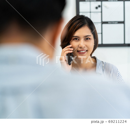 Businesswoman making a call in home office with social distance 69211224