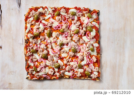 Delicious traditional Tarte Flambee from the Alsatian region of France with a thin crust of dough, tuna Delicious traditional Tarte Flambee from the Alsatian region of France with a thin crust of dough, tuna 69212010