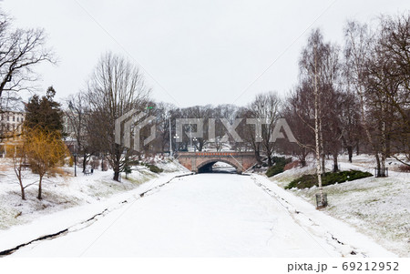 Riga Canal. A winter view along a frozen Riga canal. The canal flows through Bastion Hill park in Riga, Latvia. Riga Canal. A winter view along a frozen Riga canal. The canal flows through Bastion Hill park in Riga, Latvia. 69212952