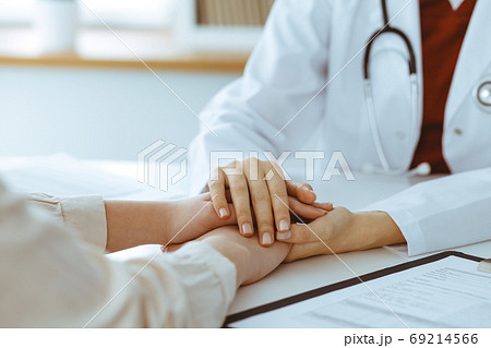 Hands of unknown woman-doctor reassuring her female patient, close-up. Medicine concept Hands of unknown woman-doctor reassuring her female patient, close-up. Medicine concept 69214566