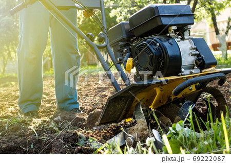 Grass and plowed soil nuggets during motor cultivator farm work Grass and plowed soil nuggets during motor cultivator farm work 69222087