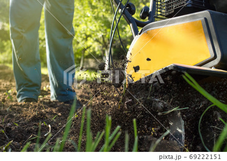 A close up view on process of working motor cultivator A close up view on process of working motor cultivator 69222151