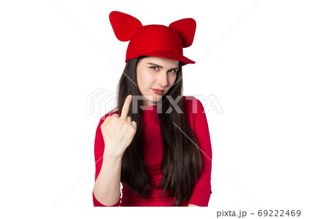 White black haired beautiful young woman with mouse ears hat and middle finger hand gesture 69222469