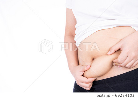 Fat woman holding excessive fat belly, overweight fatty belly isolated on over white background. 69224103