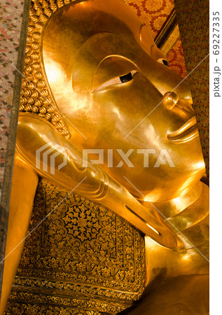 Face of the Golden Reclining Buddha Statue of Wat Pho Monastery in Bangkok of Thailand. 69227335