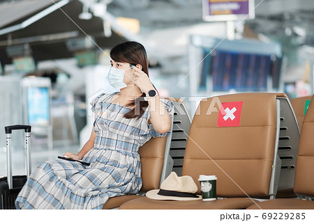 Young female wearing face mask and using mobile smartphone in ai Young female wearing face mask and using mobile smartphone in ai 69229285