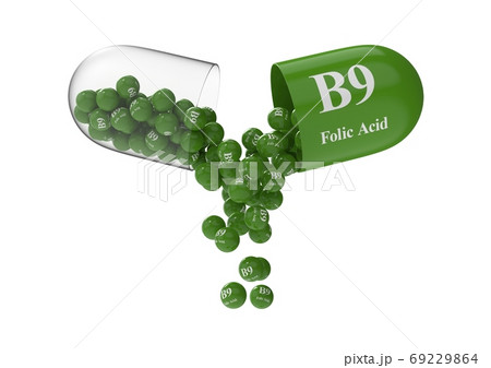 Open capsule with folic acid from which the vitamin composition is pouring Open capsule with folic acid from which the vitamin composition is pouring 69229864