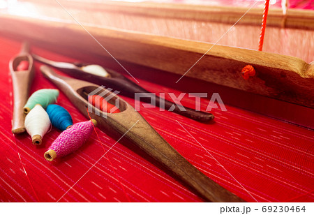 yarn in weaving shuttle tool on weaving machine. Textile. yarn in weaving shuttle tool on weaving machine. Textile. 69230464