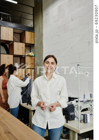 Young creative designer in jeans and white shirt standing in front of camera Young creative designer in jeans and white shirt standing in front of camera 69230907
