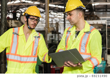 Engineer men wearing uniform safety workers perform maintenance working with laptop. 69231490