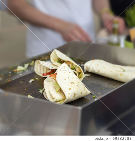 Fast food cooking. Portion of tortilla, fajitas, process of preparing. Concept of national food, healthy fast food 69232588