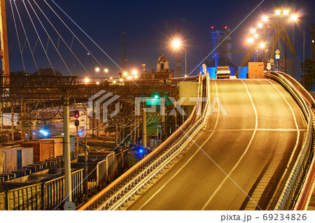 view of the industrial port in the evening - the railway and wagons deliver goods to the ships for transportation by sea 69234826