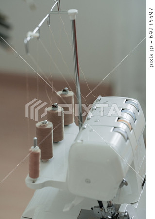 Light brown sewing thread in a row 69235697