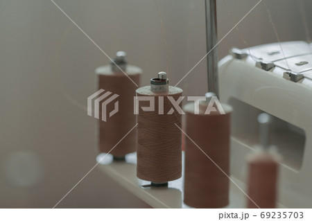 Light brown sewing thread in a row 69235703