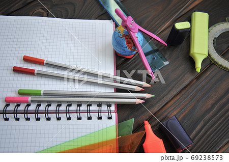 Office supplies are laid out on a wooden surface. View from above Office supplies are laid out on a wooden surface. View from above 69238573
