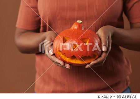 Unrecognizable Woman Holding Pumpkin 69239873