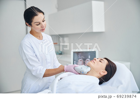 Attractive lady lying still during the ultrasound therapy Attractive lady lying still during the ultrasound therapy 69239874